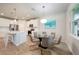 Open dining and kitchen area featuring a glass table and modern appliances at 17921 Grand Prosperity Dr, Venice, FL 34293