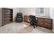 Home office with wood tile flooring, built in cabinets and desk, leather recliner and bookshelf at 17921 Grand Prosperity Dr, Venice, FL 34293