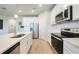 Modern kitchen features white cabinets, stainless steel appliances, and sleek countertops at 17921 Grand Prosperity Dr, Venice, FL 34293