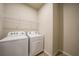 Laundry room with washer, dryer, and overhead wire shelf at 17921 Grand Prosperity Dr, Venice, FL 34293