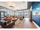 Community clubhouse lounge area features ample seating, with a large screen TV and lake views at 17921 Grand Prosperity Dr, Venice, FL 34293