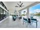 Relaxing outdoor lounge with comfortable seating, ceiling fans, and a view of the pool and landscaped area at 17921 Grand Prosperity Dr, Venice, FL 34293