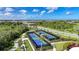 Aerial view showcasing multiple pristine pickleball courts within a vibrant, green community setting at 17921 Grand Prosperity Dr, Venice, FL 34293