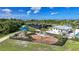 Aerial view of a charming community playground with slides, swings, and a nearby pool and amenities at 17921 Grand Prosperity Dr, Venice, FL 34293