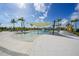 Resort-style pool with shallow entry, ample seating, palm trees, and shaded areas for ultimate relaxation at 17921 Grand Prosperity Dr, Venice, FL 34293