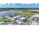 Aerial view of a vibrant town center with shops, dining, and community gathering spaces by a lake at 17921 Grand Prosperity Dr, Venice, FL 34293