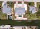 Expansive aerial shot of coastal home showcasing a private pool, boat dock, and ample driveway space at 1930 Massachusetts Ave, Englewood, FL 34224
