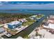 Aerial view of a waterfront home with a metal roof, pool, dock, and Gulf access at 1930 Massachusetts Ave, Englewood, FL 34224