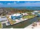 Aerial view of a waterfront home with a swimming pool, dock, and canal access to the Gulf at 1930 Massachusetts Ave, Englewood, FL 34224