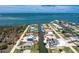 Breathtaking aerial view of waterfront home with private pool, boat dock, and stunning coastal scenery at 1930 Massachusetts Ave, Englewood, FL 34224