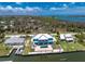 Aerial view of waterfront home with pool and dock, convenient to nearby waterways at 1930 Massachusetts Ave, Englewood, FL 34224