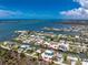 Aerial view showcases a waterfront home in a coastal community with convenient access to open waters at 1930 Massachusetts Ave, Englewood, FL 34224
