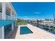 Beautiful in-ground pool overlooking canal with dock, boat lift, and tropical landscaping at 1930 Massachusetts Ave, Englewood, FL 34224