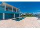 The backyard pool and patio overlook a canal with boat dock and lift at 1930 Massachusetts Ave, Englewood, FL 34224