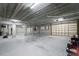 Large basement garage area with multiple overhead doors and storage space at 1930 Massachusetts Ave, Englewood, FL 34224