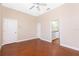 Bedroom with ceiling fan, concrete floors, and view into an en-suite bathroom at 1930 Massachusetts Ave, Englewood, FL 34224