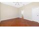 Spacious bedroom with ceiling fan, concrete floors, and a view into an en-suite bathroom at 1930 Massachusetts Ave, Englewood, FL 34224