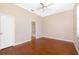 Bedroom with ceiling fan, concrete floors, and view into an en-suite bathroom at 1930 Massachusetts Ave, Englewood, FL 34224