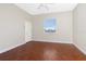 Bright bedroom with concrete floors, a ceiling fan, and a window with a view at 1930 Massachusetts Ave, Englewood, FL 34224