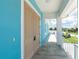 The covered entryway includes a secure double door, a full-length porch, and a neutral color palette with modern lighting at 1930 Massachusetts Ave, Englewood, FL 34224