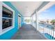 Long covered outdoor patio with blue walls overlooking waterfront view at 1930 Massachusetts Ave, Englewood, FL 34224