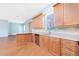 Bright and airy kitchen with stainless steel appliances, wood cabinets, and a breakfast bar at 1930 Massachusetts Ave, Englewood, FL 34224