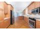 Spacious kitchen showcasing stainless steel appliances, wood cabinets, and a central island at 1930 Massachusetts Ave, Englewood, FL 34224