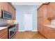 Well-equipped kitchen featuring stainless steel appliances and abundant wooden cabinetry at 1930 Massachusetts Ave, Englewood, FL 34224