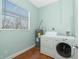 Functional laundry room with a washer, dryer, and large window at 1930 Massachusetts Ave, Englewood, FL 34224