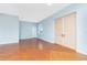 The living room includes stained concrete floors, blue walls, and large sliding doors to closets and ample natural light at 1930 Massachusetts Ave, Englewood, FL 34224