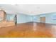 Open-concept living space featuring stained concrete floors, a ceiling fan, recessed lighting, and an adjacent kitchen area at 1930 Massachusetts Ave, Englewood, FL 34224