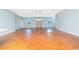 Large living room with stained concrete flooring, ceiling fans, and multiple windows offering plenty of natural light at 1930 Massachusetts Ave, Englewood, FL 34224