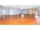 Spacious living area with stained concrete floors, ceiling fans, modern lighting, and an open floor plan at 1930 Massachusetts Ave, Englewood, FL 34224
