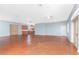 Expansive living area showcasing stained concrete floors, ceiling fans, recessed lights, and a full kitchen with stainless appliances at 1930 Massachusetts Ave, Englewood, FL 34224