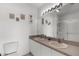 Bathroom with double sinks, a large mirror, and decorative wall art at 19375 Water Oak Dr # 203, Port Charlotte, FL 33948