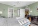 Bedroom featuring a decorative dresser and doors leading to the bath and dining room at 19375 Water Oak Dr # 203, Port Charlotte, FL 33948