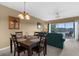Cozy dining room with seating for four, adjacent to the living room and offering a view of the patio at 19375 Water Oak Dr # 203, Port Charlotte, FL 33948
