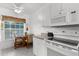 Bright kitchen nook with white cabinets and a window at 19375 Water Oak Dr # 203, Port Charlotte, FL 33948