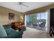 Inviting living room with comfortable seating and sliding glass doors to a patio overlooking the lake at 19375 Water Oak Dr # 203, Port Charlotte, FL 33948