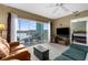 Comfortable living room with plush seating, neutral carpet, and access to a balcony overlooking the serene water view at 19375 Water Oak Dr # 203, Port Charlotte, FL 33948
