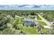 Stunning aerial view of a home with a screened-in pool, surrounded by green lawns and trees at 196 Lecturn St, Port Charlotte, FL 33954