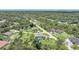 Expansive aerial view of a home nestled among lush trees and a well-maintained lawn at 196 Lecturn St, Port Charlotte, FL 33954
