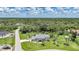 Aerial view of a beautiful home with mature trees, lush landscaping, and a well-manicured lawn at 196 Lecturn St, Port Charlotte, FL 33954