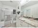 Modern bathroom featuring a glass enclosed shower, soaking tub, and updated vanity with granite countertops at 196 Lecturn St, Port Charlotte, FL 33954