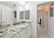 Modern bathroom with granite countertop, white cabinets, and a well-lit vanity area at 196 Lecturn St, Port Charlotte, FL 33954