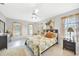 Inviting bedroom with beautiful natural lighting, a ceiling fan, and tile flooring at 196 Lecturn St, Port Charlotte, FL 33954