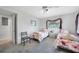Bright bedroom with twin beds, neutral walls, plush gray carpet, and an open doorway at 196 Lecturn St, Port Charlotte, FL 33954