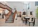 Sunlit dining room featuring high ceilings, wooden stairs, and backyard views at 196 Lecturn St, Port Charlotte, FL 33954