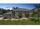 Stately two-story home featuring lush landscaping, a portico entrance, and mature palm trees at 196 Lecturn St, Port Charlotte, FL 33954