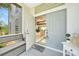 Inviting entryway with double doors, a bench, and a view into the home's interior at 196 Lecturn St, Port Charlotte, FL 33954